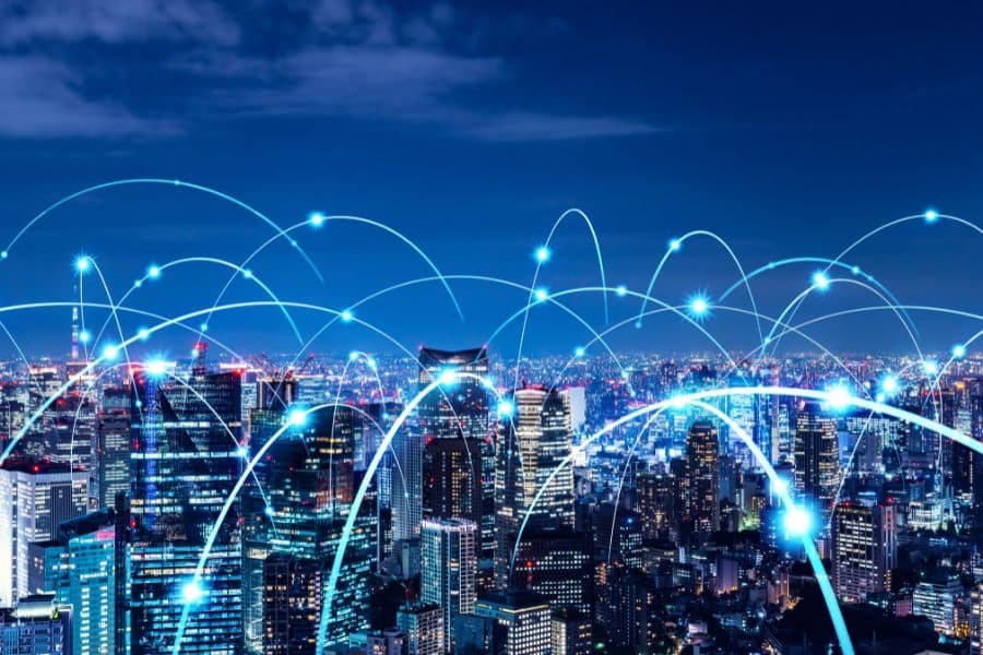 5G PCB revolution with base stations and IoT devices in a high-tech cityscape