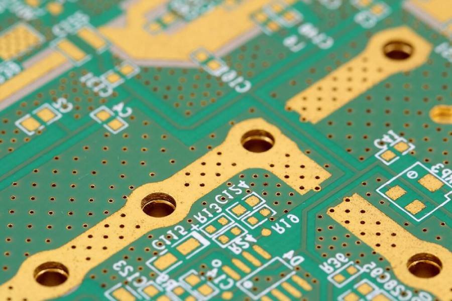 Macro shot of etched copper traces and vias on a printed circuit board, showcasing antistatic and electromagnetic shielding properties of copper foil in PCB assembly.