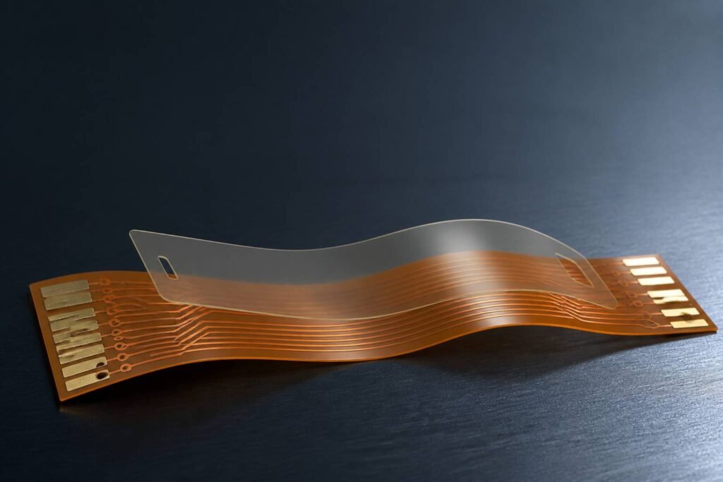 Flexible PCB coverlay structure protecting pads and traces