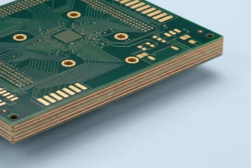 Bare multilayer PCB with visible laminated board edge and copper layers