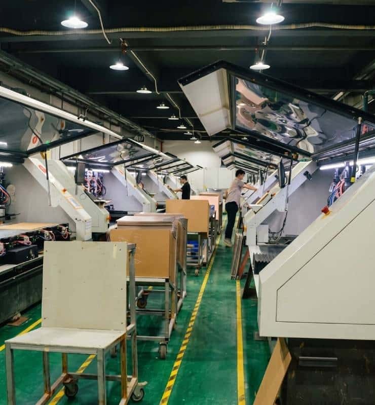 PCBelec's quick turn PCB prototype manufacturing facility: Automated drilling workshop showcasing professional equipment and operators.